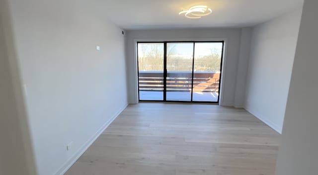 unfurnished room with light wood-type flooring