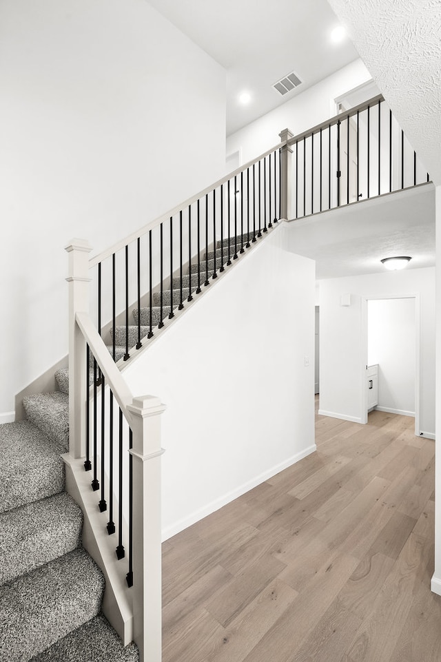 stairway featuring hardwood / wood-style floors