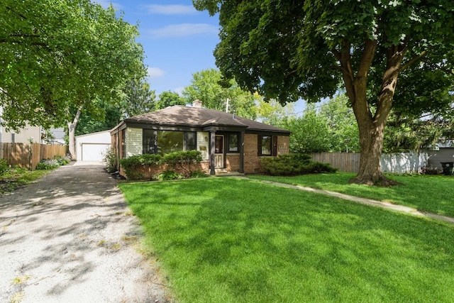 ranch-style home featuring a front lawn, an outdoor structure, and a garage