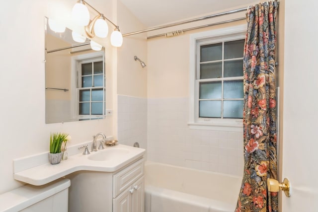 bathroom featuring vanity and shower / bath combo