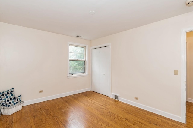 unfurnished room featuring wood-type flooring