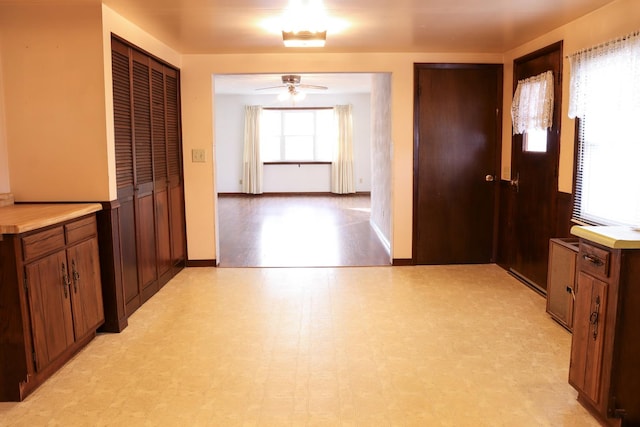 401 Ash Ave, Morrison, IL 61270 - kitchen featuring light floors, ceiling fan, and brown cabinetry