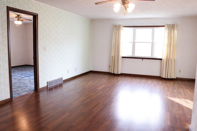 unfurnished room featuring ceiling fan and dark hardwood / wood-style flooring