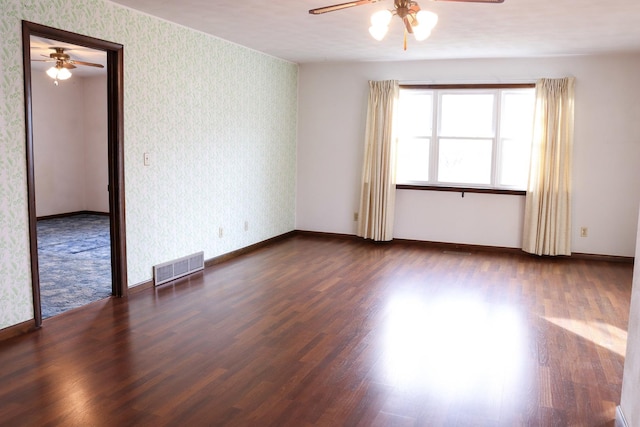 401 Ash Ave, Morrison, IL 61270 - empty room with ceiling fan, wallpapered walls, and wood finished floors