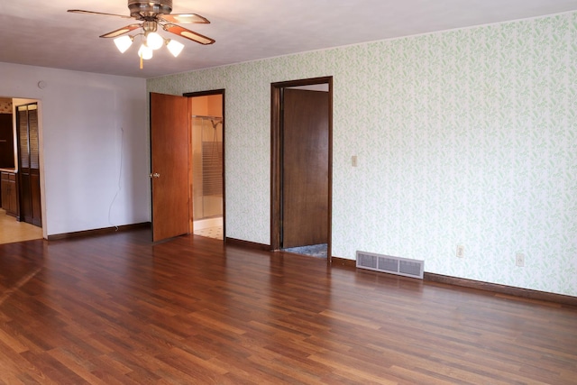 unfurnished room with ceiling fan and dark wood-type flooring