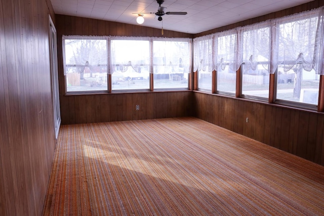 unfurnished sunroom with ceiling fan, a healthy amount of sunlight, and vaulted ceiling