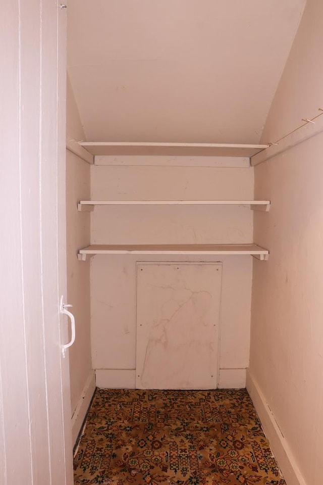 walk in closet featuring lofted ceiling