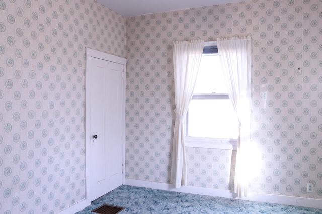 401 Ash Ave, Morrison, IL 61270 - unfurnished bedroom featuring wallpapered walls and baseboards