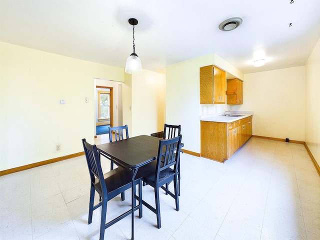 dining space with light floors and baseboards