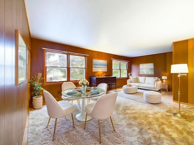 dining area featuring wooden walls