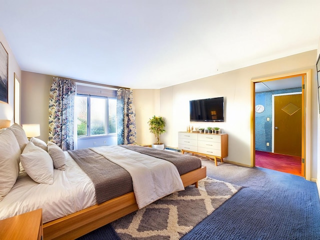 carpeted bedroom featuring baseboards