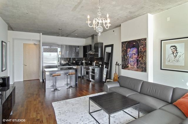 living room featuring dark hardwood / wood-style flooring and an inviting chandelier