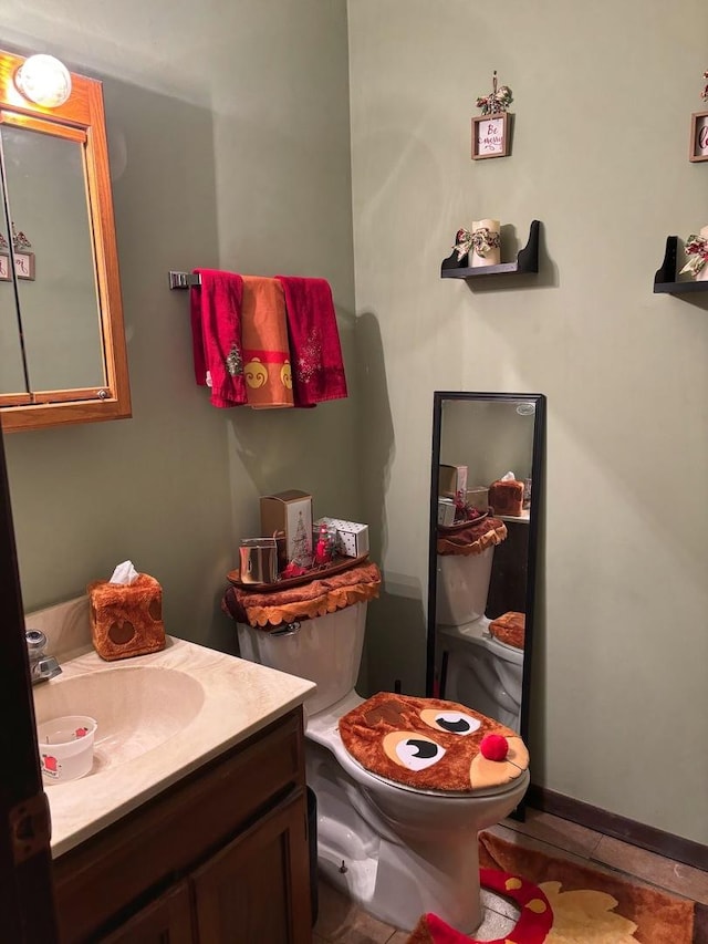 bathroom featuring tile patterned flooring, vanity, and toilet