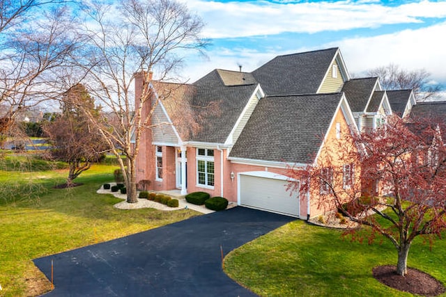 view of front of house with a front lawn and a garage