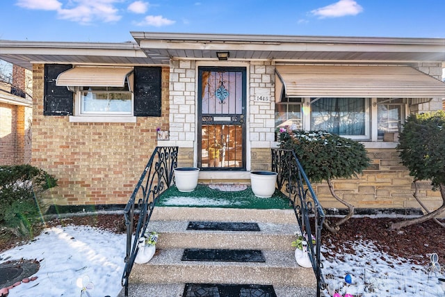 view of snow covered property entrance