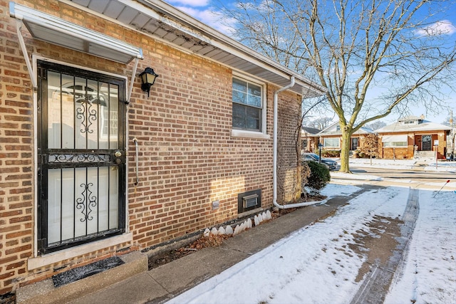 view of snow covered property entrance