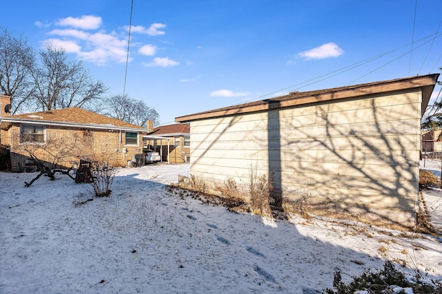 view of snow covered rear of property