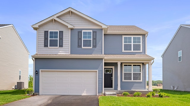 view of front facade featuring a garage, central air condition unit, and a front yard