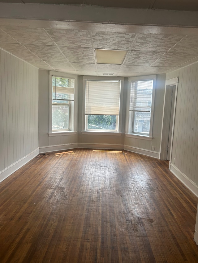 empty room with dark wood-type flooring