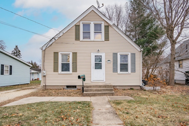 bungalow-style home with a front yard