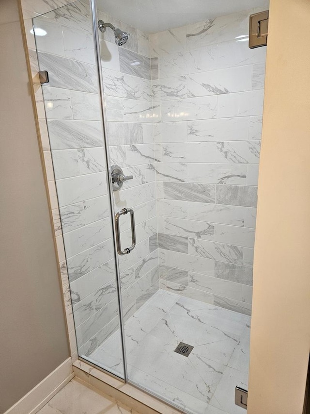 bathroom with a shower with shower door