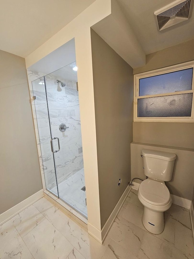 bathroom featuring toilet and a shower with door