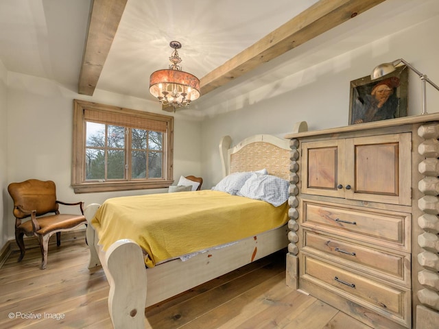 bedroom featuring beamed ceiling, a notable chandelier, and light wood-type flooring