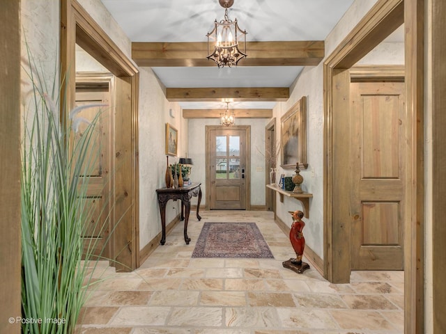 entryway featuring beamed ceiling and an inviting chandelier