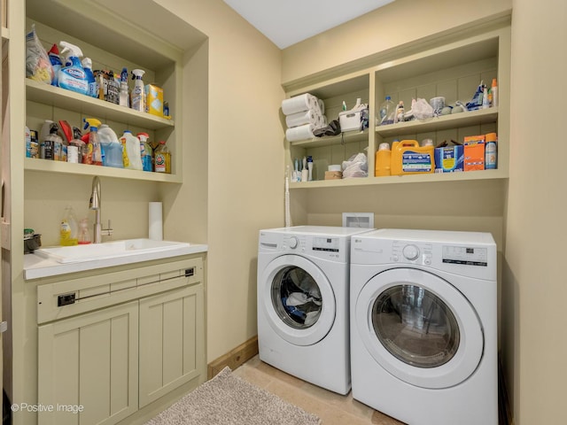 laundry room featuring separate washer and dryer, sink, light tile patterned flooring, and cabinets