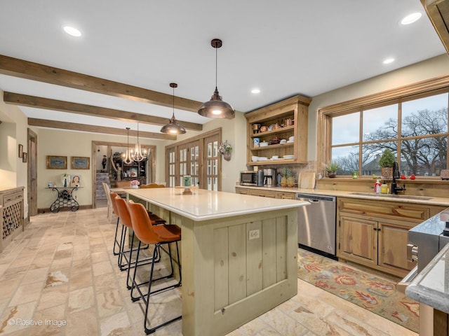 kitchen featuring dishwasher, sink, an inviting chandelier, a breakfast bar area, and a kitchen island