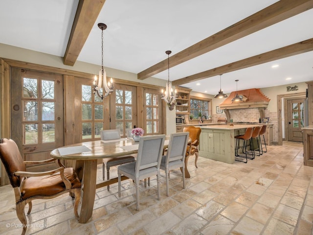 dining area with beamed ceiling, french doors, a notable chandelier, and sink