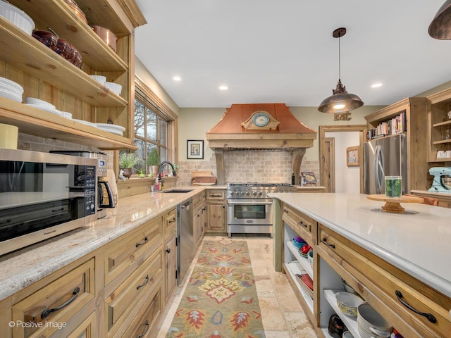 kitchen featuring tasteful backsplash, custom range hood, stainless steel appliances, sink, and pendant lighting