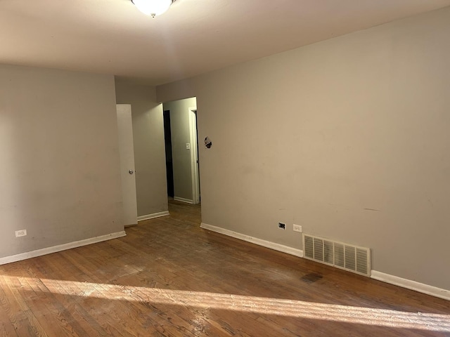 spare room with hardwood / wood-style floors