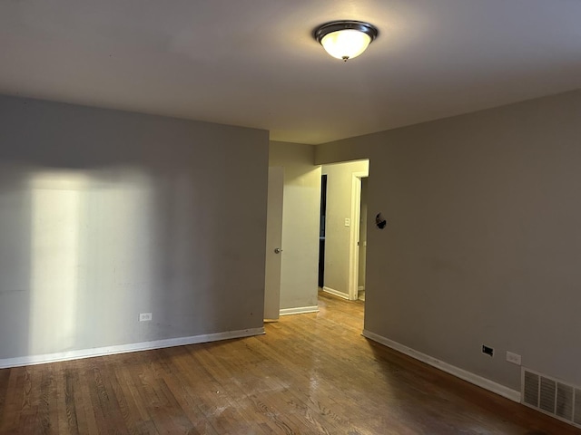 unfurnished room featuring hardwood / wood-style flooring