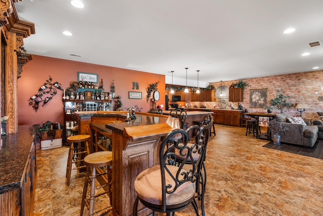 bar with black microwave, bar area, visible vents, and recessed lighting