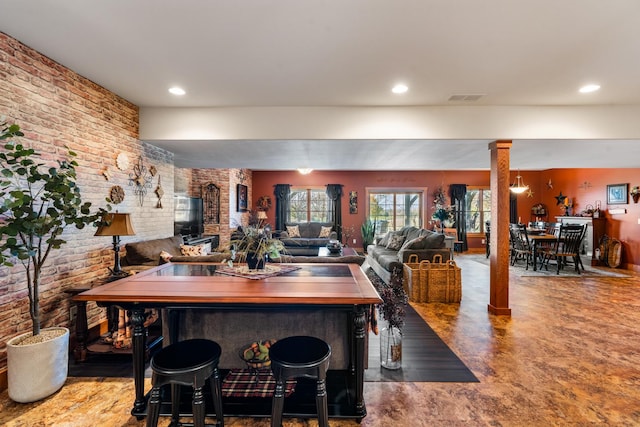 dining space with recessed lighting, brick wall, visible vents, and ornate columns