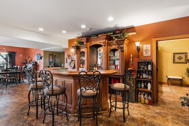 bar featuring a dry bar, baseboards, and recessed lighting