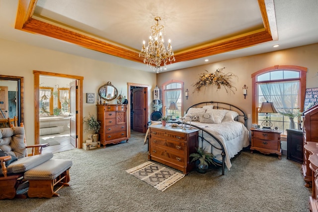 carpeted bedroom with ornamental molding, a tray ceiling, a closet, and a spacious closet