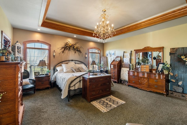 bedroom with a chandelier, dark colored carpet, multiple windows, and a raised ceiling