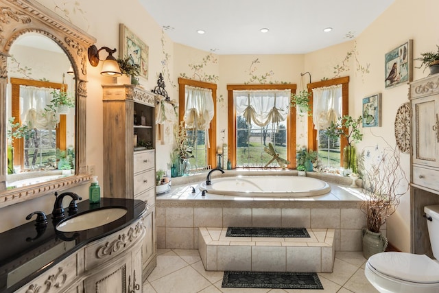 bathroom with toilet, recessed lighting, vanity, a bath, and tile patterned floors