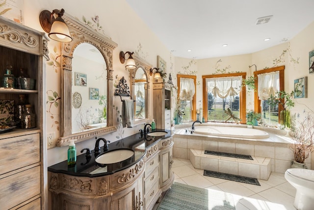 bathroom with visible vents, a sink, a bath, and tile patterned floors