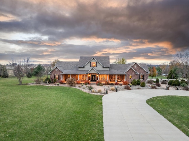 view of front of property with concrete driveway and a front yard