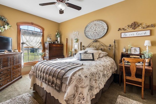 bedroom featuring dark colored carpet and a ceiling fan