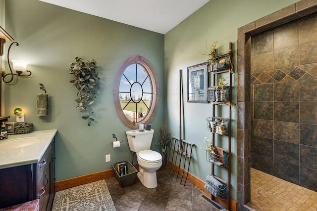 bathroom with visible vents, toilet, vanity, a walk in shower, and baseboards