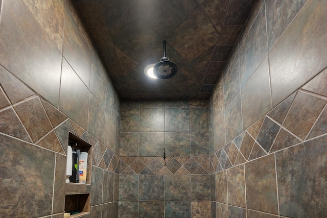 interior details featuring a tile shower