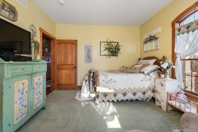 bedroom featuring light colored carpet, multiple windows, and visible vents