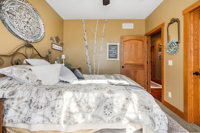 bedroom featuring ceiling fan, visible vents, and baseboards