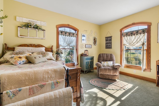 bedroom with carpet floors and baseboards