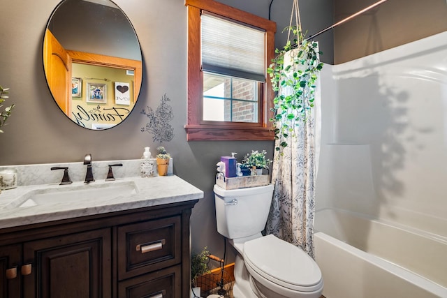 bathroom featuring toilet, shower / bath combo with shower curtain, and vanity