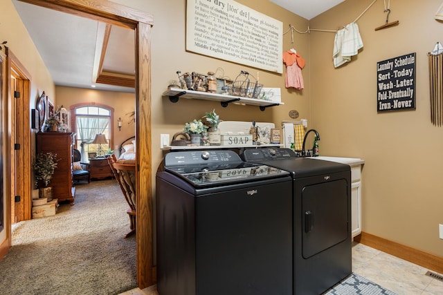 clothes washing area featuring light colored carpet, cabinet space, visible vents, separate washer and dryer, and baseboards